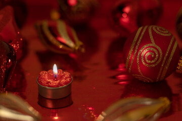 Christmas still life with red baubles and candle
