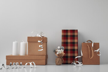 Gift boxes and packages on a light background and festive decor. Copy space, mock up.