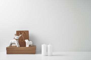 Porcelain figurine of a deer and a bull and New Year's, festive decor. Copy space, mock up.