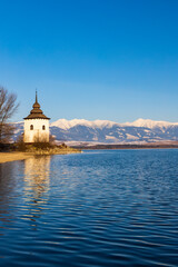 Obraz premium Church of Virgin Mary in Havranok and lake Liptovska Mara, district Liptovsky Mikulas, Slovakia
