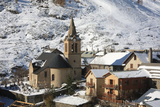 Enchanting Village (le Chazelet) with old stone church in the Hautes Alpes department in the French Alps in winter