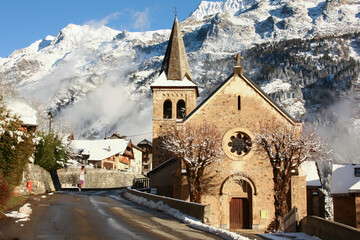 Fototapeta na wymiar Gorgeous winter scene of an old stone church in the Oisans region in the department of Isère in the French Alps