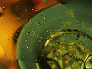 Abstract photography. Multi-colored circles on a multi-colored background. Red, yellow, pink, green, purple circles. Drops of oil on the water. Bokeh. The background