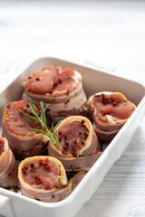 pork tenderloin in bacon on pepper
