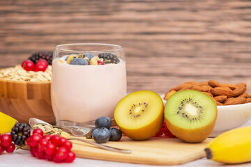 Group Fruits Breakfast with bread Whole grains and nuts, yogurt mix with Cherry , banana, avocado in the wooden table. Breakfast for Health and Diet concept
