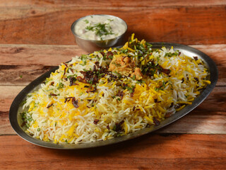 Traditional hyderabadi Vegetable / veg dum biryani with mixed veggies served with mixed raita, selective focus