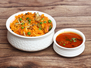 Traditional Vegetable / veg biryani with mixed veggies served with curry, selective focus