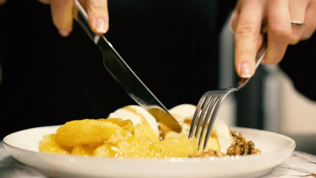 Girl eating ice cream with a fork and knife