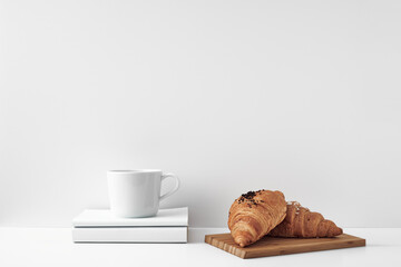 Mug and croissants on a white background. Eco-friendly and natural materials in the decor, dessert. Copy space, mock up.