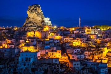 Beautiful night view of Ortahisar in Cappadocia, Turkey and amazing ancient jagged castle which was...