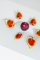 Bright juicy ripe figs on a white background cut into pieces. The concept of healthy food.
