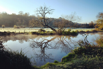 A still River Wey on a cold sunny morning in Godalming, Surrey, UK
