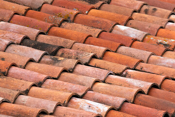 Vintage clay tiled roof. Multi colored old roof tiles background.