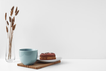 Mug and donuts cakes on a white background. Confectionery, coffee shop. Copy space, mock up.