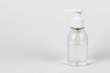 Sanitizer with antibacterial liquid. Pump bottle with antimicrobial transparent liquid gel on white background.