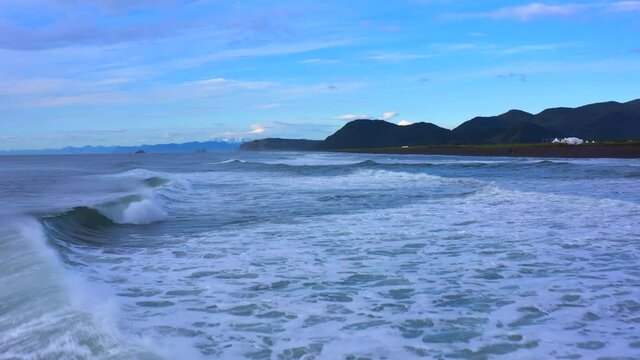 Waves in the Pacific Ocean. Avachinsky Bay. Khalaktyrsky beach. Aerial view of the volcanoes of Kamchatka. Calming natural background.