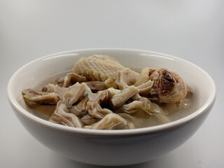 Chicken wings soup cooked with beef tripe.served in a white bowl. The innards is Very tasty and delicious