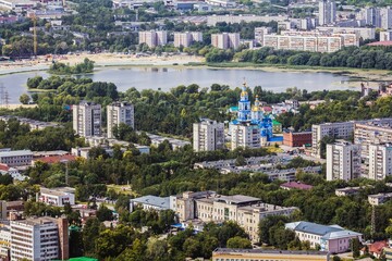 Aerial view of residential district of Ulyanovsk, beautiful blue Holy Ascension Cathedral with golden domes and the river Sviyaga on the background. Summer. Russia.