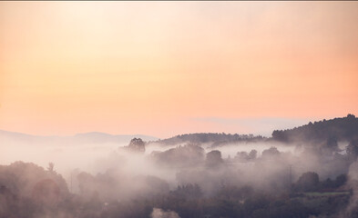 Obraz premium Sunrise on a foggy day with an orange sky