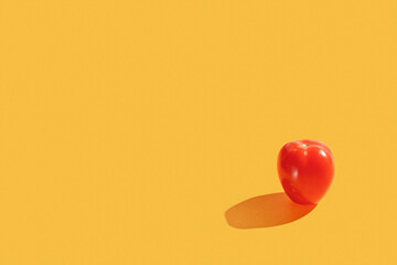 Red cherry fresh tomato on yellow background. Minimal trendy composition. Healthy organic vegan food concept. Organic farming concept