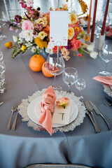 Close up of wedding table with flowers and shiny dishware