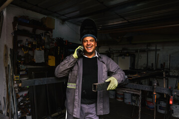 Blacksmith Using Phone in Workshop