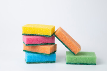 Colored sponges for washing dishes on a white background.