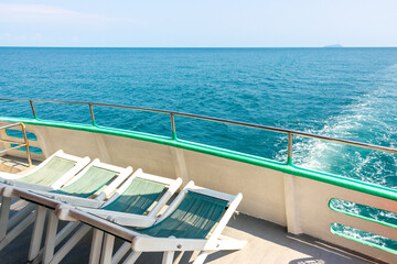Fototapeta premium Empty deck chairs on the upper deck of a cruise ship. Sun loungers on the sea yacht for relaxing