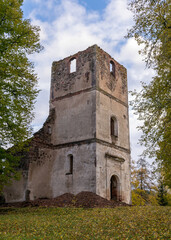 Fototapeta na wymiar landscape with old church ruins, ruins overgrown with bushes and grass, autumn time, Ergeme Evangelical Lutheran Church was one of the most beautiful churches in Latvia