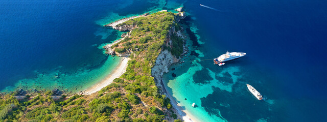 Aerial drone top down ultra wide photo of luxury yacht anchored in tropical exotic island turquoise...