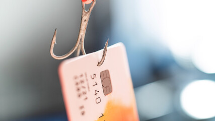 Close-up of a credit card on a fishing hook