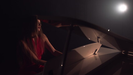 4K Footage Of Female Pianist Plays In Beautiful Grand Piano On Stage In Concert . A woman plays the...