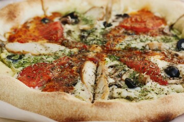 Italian pizza with chicken tomatoes and cheese