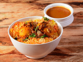 Egg Biryani - Basmati rice cooked with masala roasted eggs and spices and served with mirchi ka salan, selective focus
