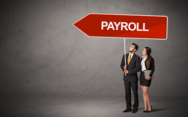 Young business person in casual holding road sign with PAYROLL inscription, new business direction concept