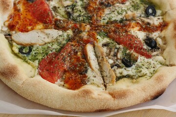 Italian pizza with chicken tomatoes and cheese