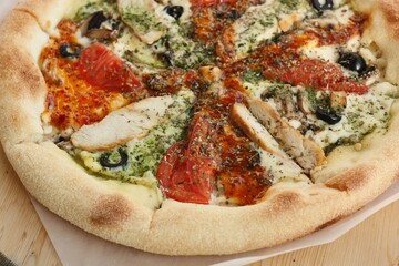 Italian pizza with chicken tomatoes and cheese