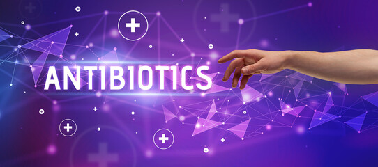 Close-Up of cropped hand pointing at ANTIBIOTICS inscription, medical concept