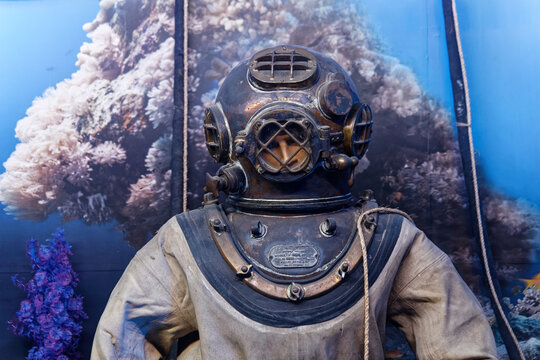 Old vintage diving helmet with a dummy mannequin inside. Rusty surface and underwater decoration background at Rahmi M. Koc Classic Cars Museum in Istanbul / Turkey - November 23 2019.