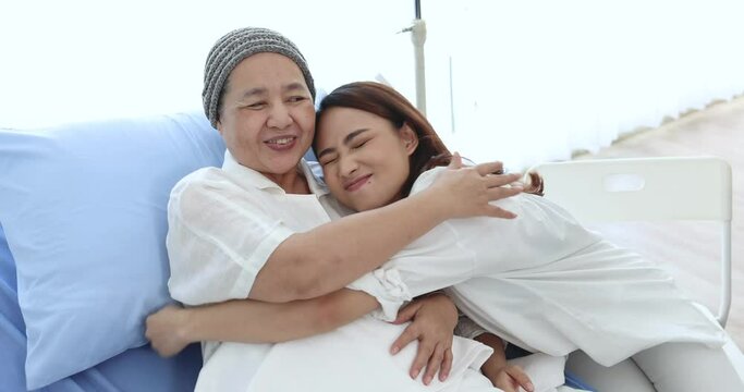 Asian woman visited her mother in the hospital, She takes care of her mother closely as well as hugs her for support.