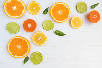 Lemons, lime, orange and grapefruit cut in circles on a white background with space for text. Poster, banner, article.