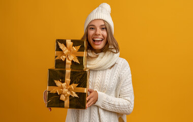 young smiling happy pretty woman holding golden present boxes celebrating new year, christmas...