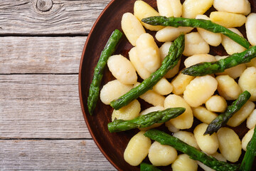 Italian homemade potatoes gnocchi with asparagus
