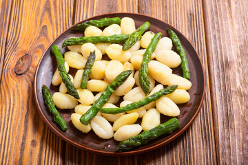 Italian homemade potatoes gnocchi with asparagus