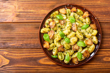 Homemade potatoes gnocchi with basil , cheese and mushrooms