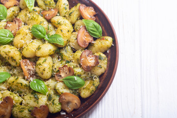 Homemade potatoes gnocchi with basil , cheese and mushrooms