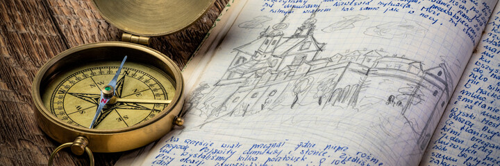 Fototapeta na wymiar Vintage brass compass and old travel journal with handwriting and pencil sketches (property release attached), travel concept.