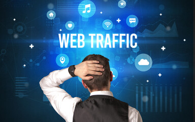 Rear view of a businessman with WEB TRAFFIC inscription, modern technology concept