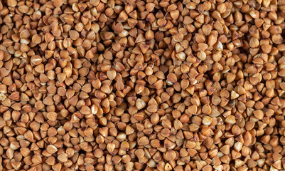 Organic uncooked buckwheat grain pattern background