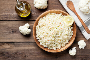 Homemade organic  cauliflower rice with spice in a wooden bowl.